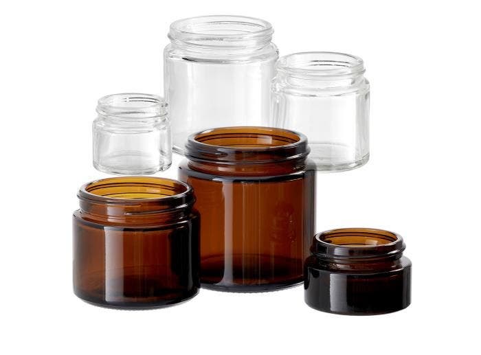 An image of several Simplicity Glass Jars that are both clear and amber in different sizes