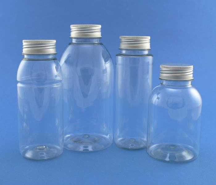 A picture of 4 empty bottles with aluminium closures