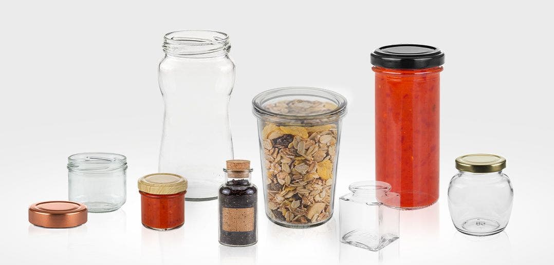 picture of glass jars laid out some empty some with food inside. 